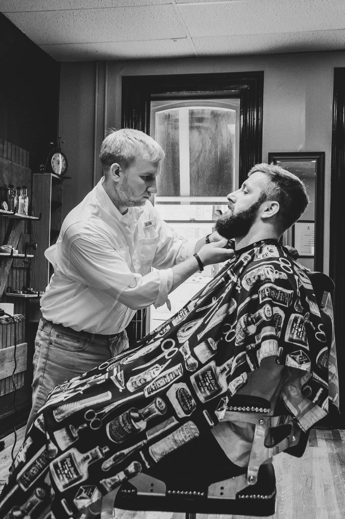 Barber Trimming Beard Black & White